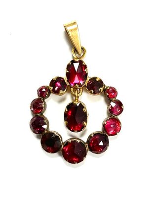 a close up of a pendant with red stones on a white background