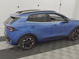 the rear end of a blue car parked in a garage