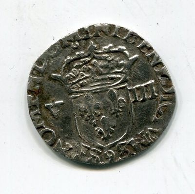 une vieille pièce d'argent surmontée d'une couronne