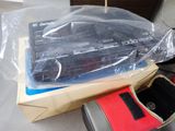 a box with a remote control and other items on a table