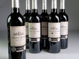 several bottles of wine are lined up in a row on a table