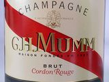a bottle of champagne with a red stripe on the label
