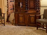 an image of a living room with a tall wooden cabinet