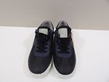 navy blue leather sneakers with white soles on a white surface