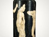 a black vase with a picture of two women on it