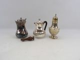 three silver coffee pots sitting next to each other on a table