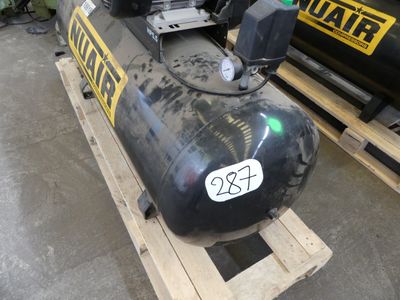 a black tank sitting on a pallet in a warehouse