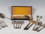 a lot of spoons and forks in a box