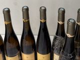 several bottles of wine are lined up on a counter