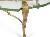 an image of a glass table with a gold metal frame and a glass top