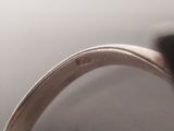 a close up of a silver ring with a diamond on it