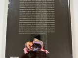 the back cover of a book with a picture of a person holding a piece of food