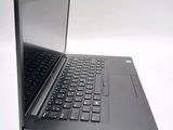 a black laptop with a blue keyboard on a white surface