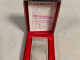 an old cigarette case with a cigarette in it sitting on a table