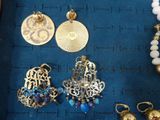 a lot of jewelry that is laying out on the table