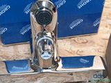 a close up of a faucet with a box in the background
