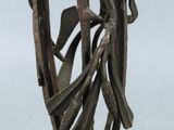 statue of a woman holding a bird on a metal base