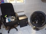 a black chair and a black chair in a small room