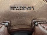 the back of a brown leather chair with the word studio written on it