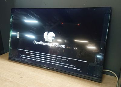 a flat screen tv sitting on top of a wooden table