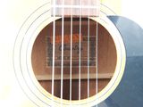 a close up of an acoustic guitar with a wooden case