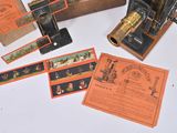 a box of old fashioned sewing machines on a table
