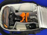 a bag with a camera and other items inside of it