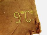 a brown piece of cloth with the number nine on it