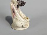 figurine of a woman with a dog on her lap
