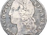 gros plan d'une pièce de monnaie sur laquelle figure une tête de femme