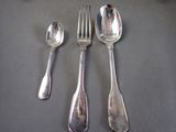 four silver spoons and two silver spoons on a table