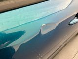 a close up of a car door with a hole in it