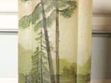 a picture of a vase with a picture of trees on it