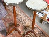 two tables that are sitting on a rug in a room