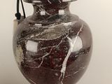 a lamp that is sitting on a table next to a vase