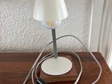 a lamp that is sitting on a table with a cord