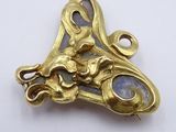 an image of a close up of a gold plated object on a white surface