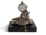 a clock that is sitting on top of a marble block