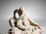 marble statue of a man and a woman sitting on a rock