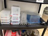 many plastic containers on a shelf in the kitchen
