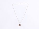 a gold necklace with a blue stone pendant on a white background