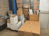 a room with a lot of boxes and a refrigerator