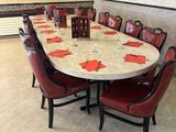 a round table with red chairs around it in a room