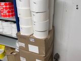 several rolls of toilet paper stacked on top of a pallet in a room