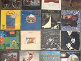 a lot of records on the wall of a room