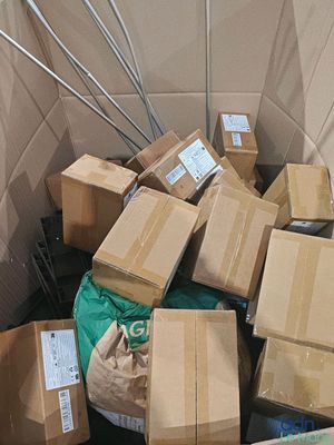 a pile of boxes in the middle of a room