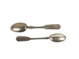 two spoons that are sitting next to each other