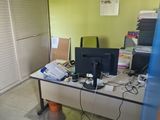 a desk with a computer and a monitor in a room