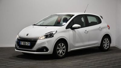 a white car parked in a room with a black floor