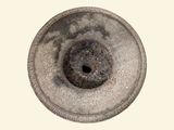 an image of a stone vase with a hole in it